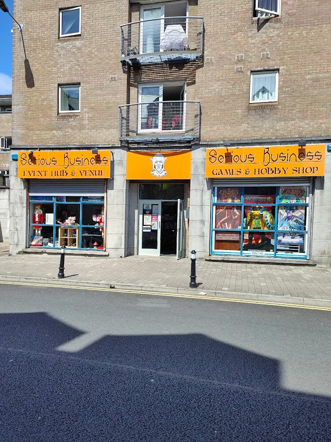Serious Business double storefront on JFK Parade, Sligo - orange signage for Games & Hobby Shop and Event Hub & Venue