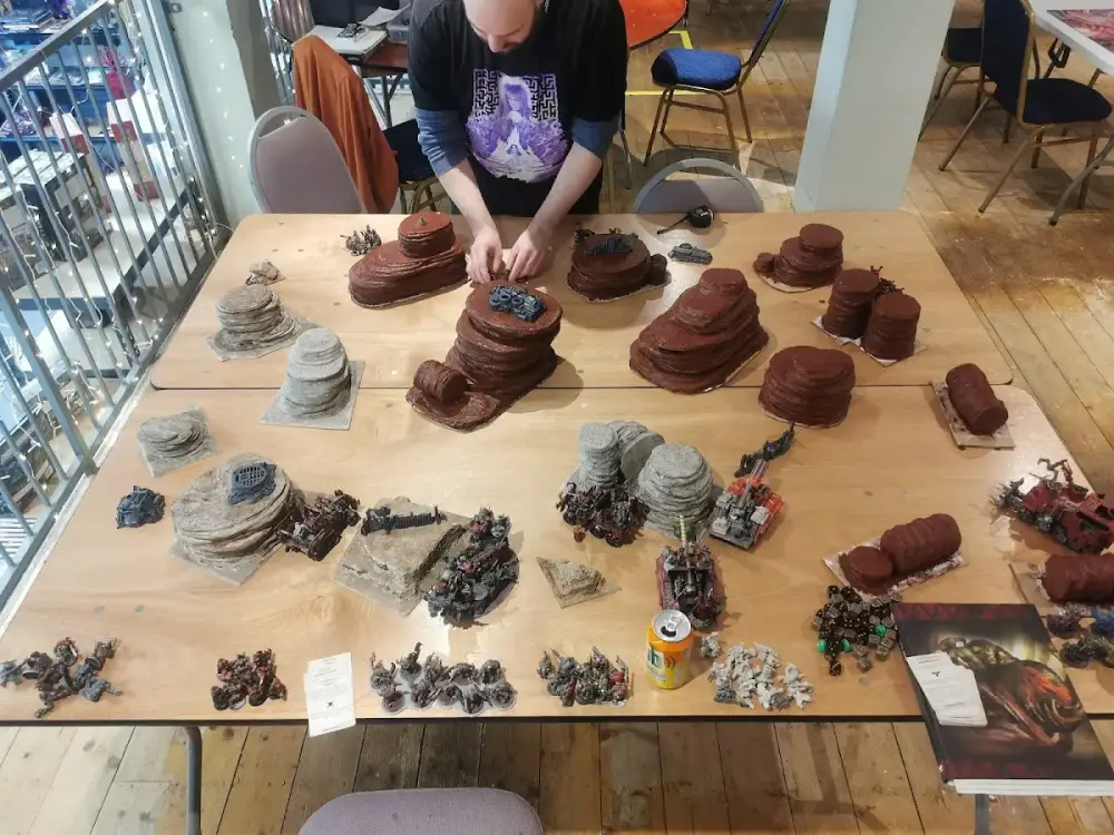 Warhammer player building terrain for a tabletop battle